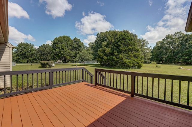 wooden terrace featuring a lawn