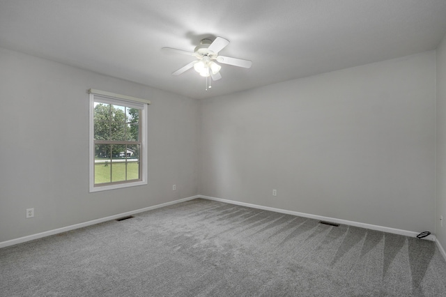 carpeted spare room featuring ceiling fan