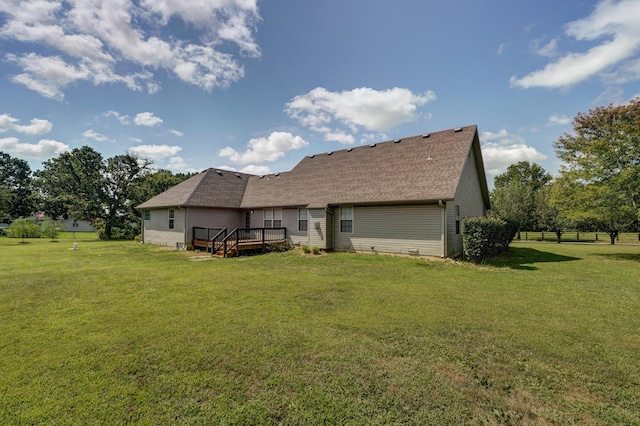 back of house with a wooden deck and a yard