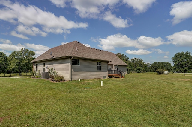 view of home's exterior with a yard and central air condition unit