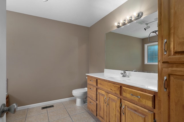 bathroom with vanity, tile patterned floors, and toilet