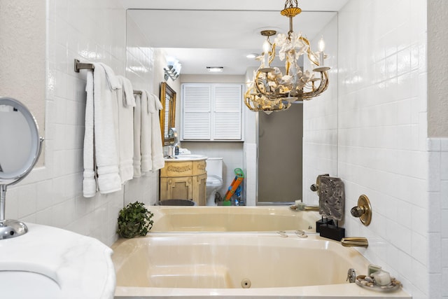 bathroom featuring a tub, tile walls, an inviting chandelier, and toilet