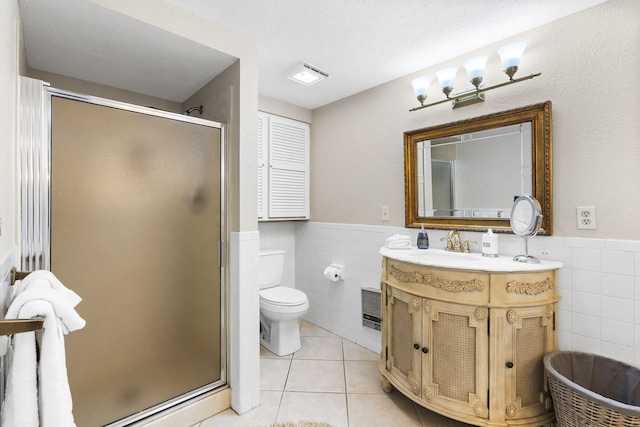 bathroom featuring vanity, an enclosed shower, tile patterned floors, and toilet