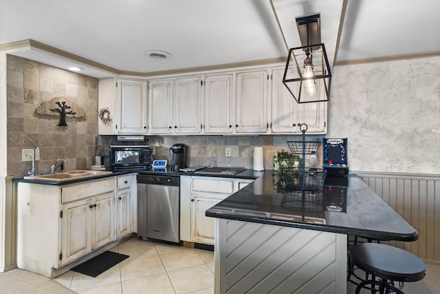 kitchen featuring dishwasher, sink, a kitchen bar, hanging light fixtures, and light tile patterned floors