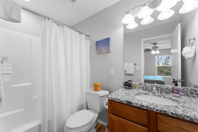 full bathroom featuring vanity, shower / tub combo, and toilet