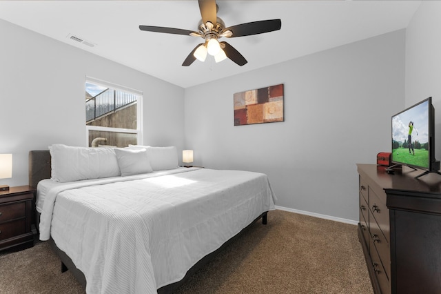 bedroom with ceiling fan and dark carpet