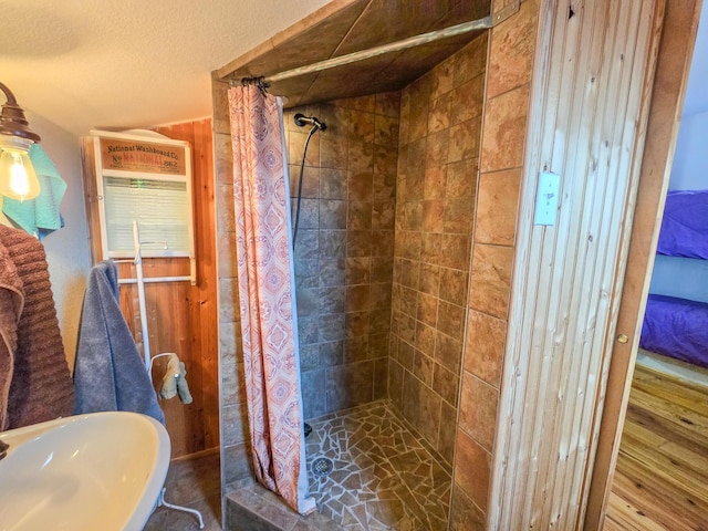 bathroom with sink, curtained shower, and a textured ceiling