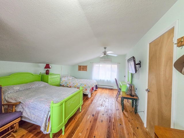 bedroom featuring hardwood / wood-style flooring, a baseboard radiator, lofted ceiling, and ceiling fan