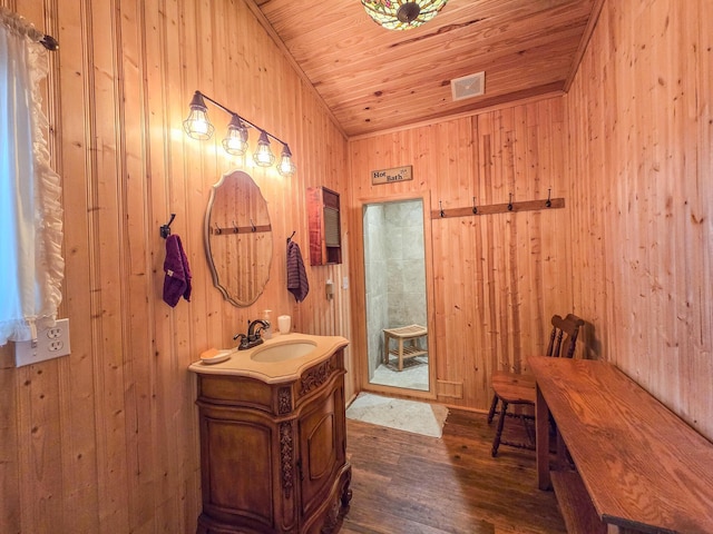 bathroom with vanity, hardwood / wood-style flooring, wooden walls, and wooden ceiling