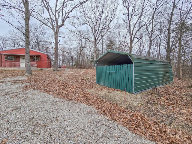 view of outbuilding featuring a carport and a porch