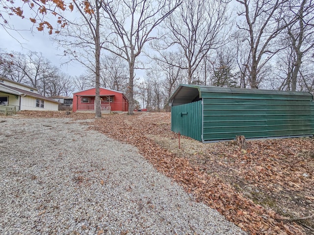 exterior space featuring an outbuilding and a carport