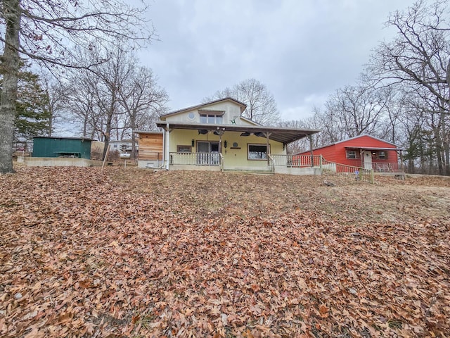 back of house featuring a porch