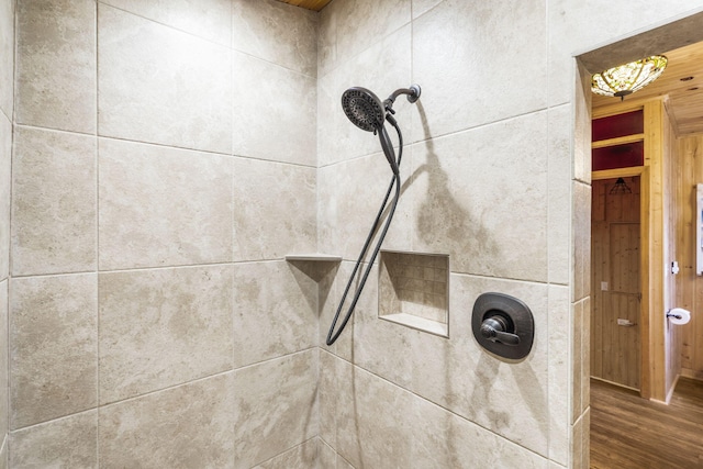 interior details featuring a tile shower