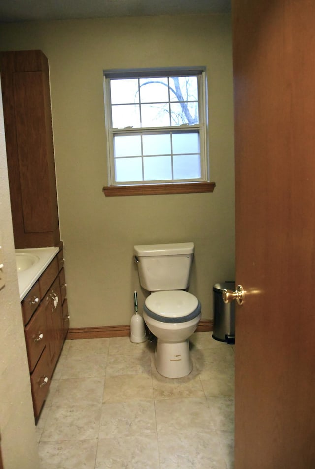 bathroom featuring vanity, tile patterned flooring, and toilet