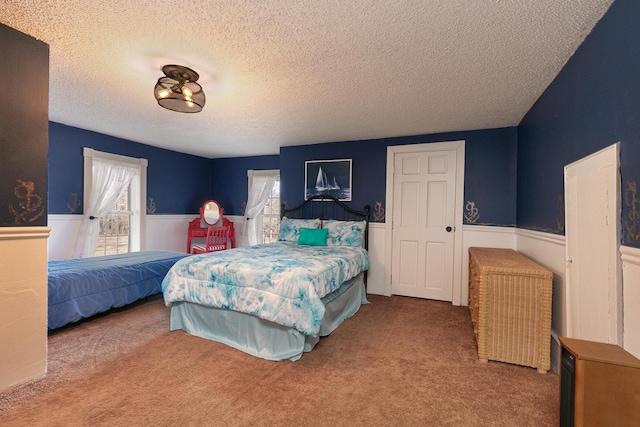 carpeted bedroom with a textured ceiling