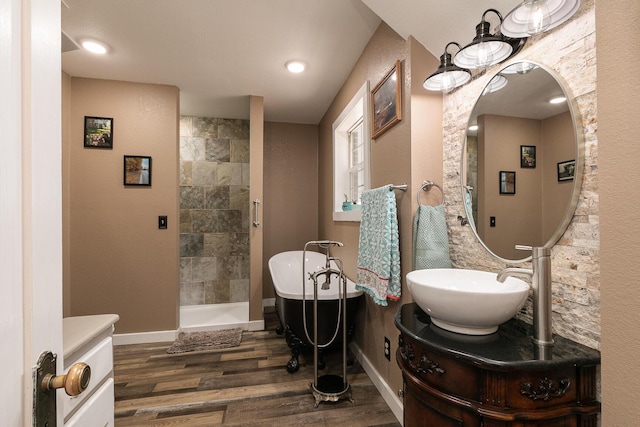 bathroom featuring hardwood / wood-style flooring, vanity, and a bathtub