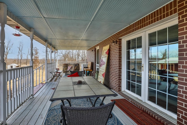 wooden terrace featuring covered porch