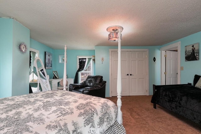 bedroom with a closet, a textured ceiling, and carpet