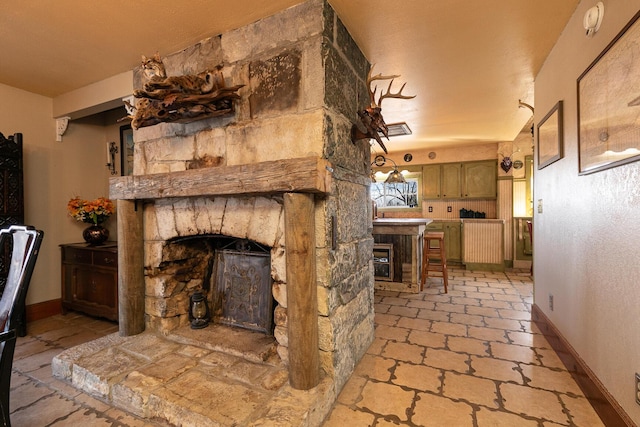 living room featuring a stone fireplace