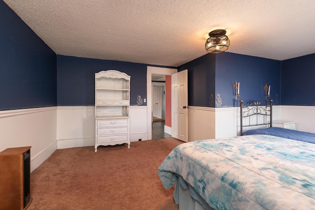 carpeted bedroom featuring a textured ceiling