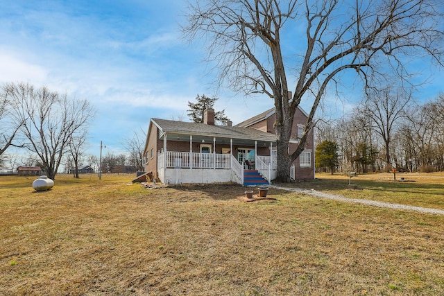 view of front of house with a front yard and covered porch