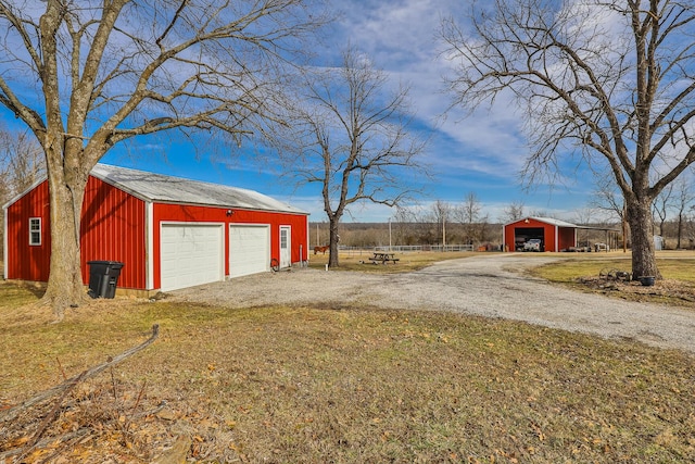 exterior space featuring an outbuilding and a garage