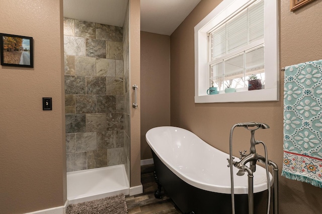 bathroom with hardwood / wood-style flooring and shower with separate bathtub