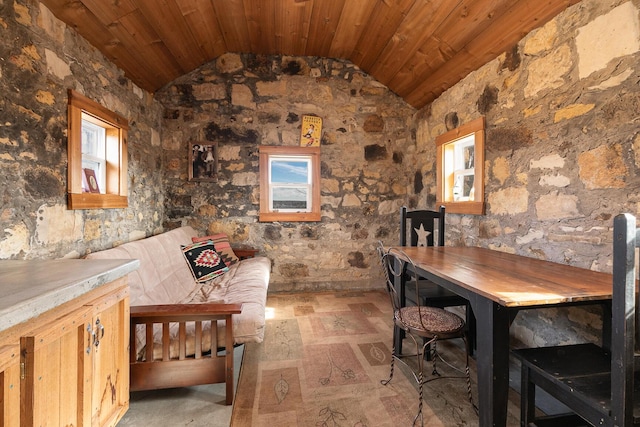 unfurnished dining area featuring wood ceiling and vaulted ceiling