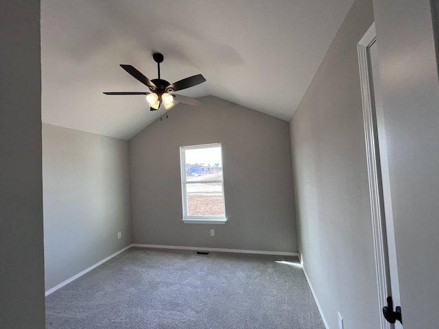 unfurnished room with ceiling fan, vaulted ceiling, and carpet