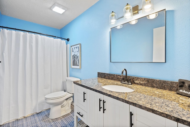 bathroom featuring vanity, tile patterned floors, toilet, and a textured ceiling