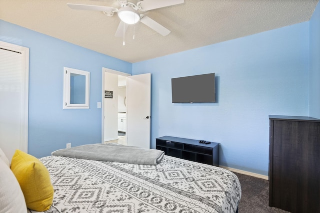 bedroom with ceiling fan, a textured ceiling, and dark colored carpet