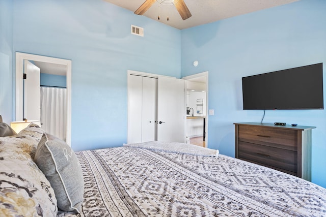 bedroom with sink, a closet, ceiling fan, and a high ceiling