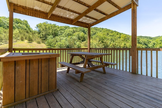 wooden terrace featuring a water view