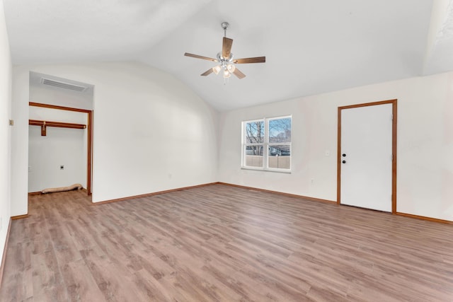 spare room with ceiling fan, vaulted ceiling, and light hardwood / wood-style flooring