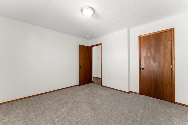 empty room featuring carpet flooring and a textured ceiling