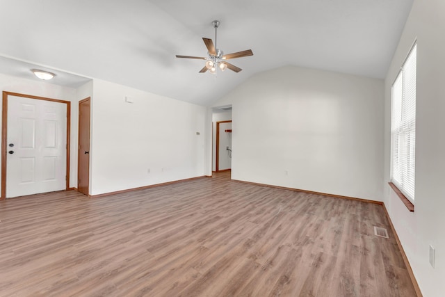 unfurnished room featuring lofted ceiling, light hardwood / wood-style floors, and ceiling fan