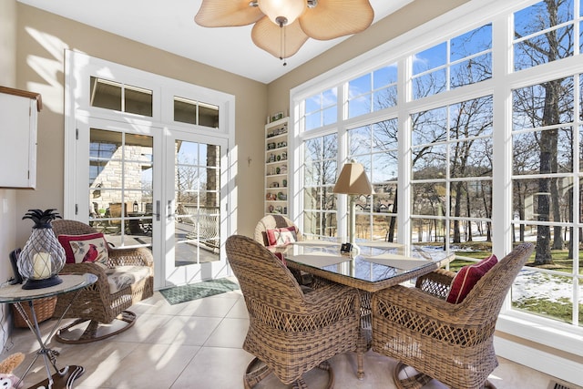 sunroom featuring french doors, ceiling fan, and a wealth of natural light