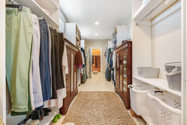 walk in closet with light tile patterned floors