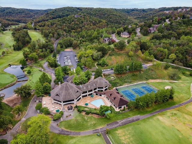 birds eye view of property with a view of trees and a water view