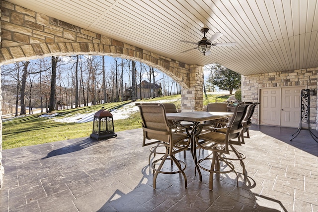 view of patio featuring outdoor dining area and ceiling fan