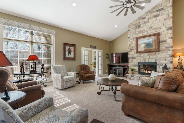 living area with carpet flooring, plenty of natural light, a fireplace, and high vaulted ceiling