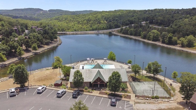 aerial view with a wooded view and a water view