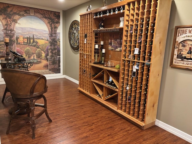 wine room featuring wood finished floors and baseboards