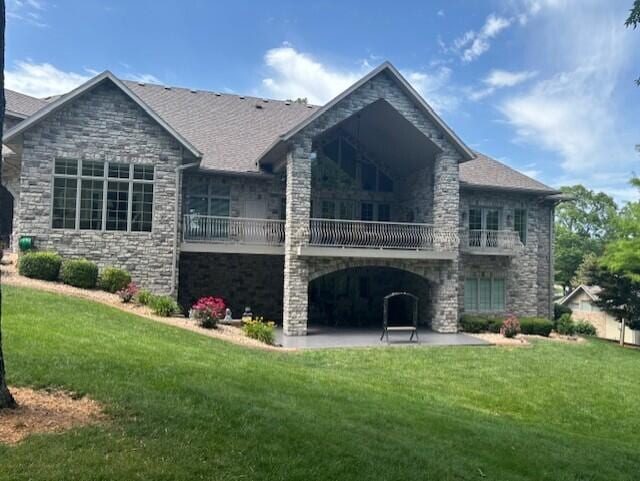119 Silver Oak Way, Branson West, MO 65737 - back of property with a balcony, a patio, a yard, and stone siding
