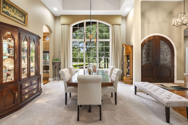 119 Silver Oak Way, Branson West, MO 65737 - dining space featuring arched walkways, a chandelier, a towering ceiling, light colored carpet, and recessed lighting
