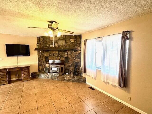 160 Old Glory Rd, Branson, MO 65616 - unfurnished living room featuring ceiling fan, tile patterned floors, and a textured ceiling