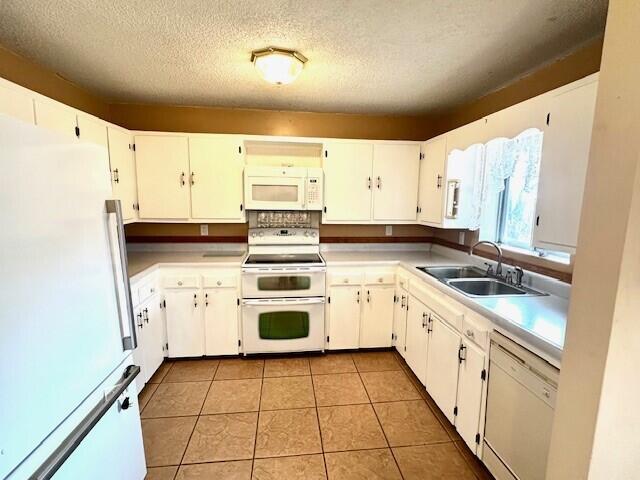 160 Old Glory Rd, Branson, MO 65616 - kitchen featuring sink, white appliances, light tile patterned floors, and white cabinets