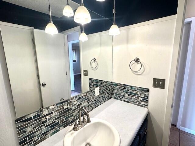 160 Old Glory Rd, Branson, MO 65616 - bathroom with tile patterned flooring, vanity, and decorative backsplash