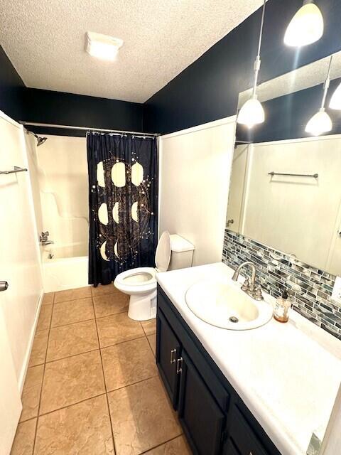 160 Old Glory Rd, Branson, MO 65616 - full bathroom featuring vanity, shower / bath combination with curtain, a textured ceiling, tile patterned floors, and toilet