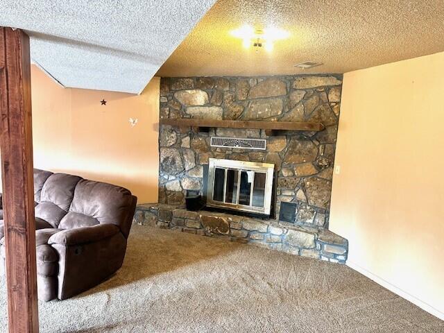 160 Old Glory Rd, Branson, MO 65616 - carpeted living room featuring a fireplace and a textured ceiling
